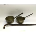 Two walking sticks and two brass pans (4).