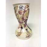 A Moorcroft vase of unusual shape decorated with orchids on a pale cream ground a trial vase dated