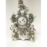 A quality late 19th century German porcelain clock the case encrusted with raised flowers with two