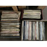 A large collection of LPs in three boxes and one record case.