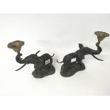 A pair of spelter candle holders in the form of el