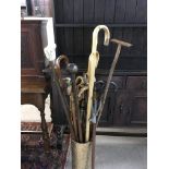 A large collection of walking sticks including a Lignum Vitae Knobkerrie, inlaid ebonised stick,