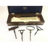 Four vintage corkscrews and a glove box with contents.