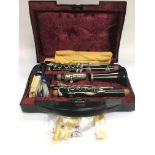 A cased Boosey & Hawkes clarinet with accessories.