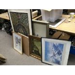 A collection of various paintings and framed photographs with some in needs of restoration