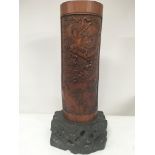 A mid 20th century Chinese carved bamboo vase on a
