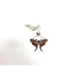 A large silver butterfly necklace set with cabochone rubies, marcasite, and multi coloured pliqu a