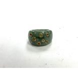 A jade and 9ct gold ring inset with semi precious stones.