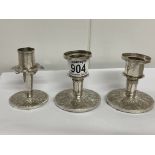 A set of three Malaysian white metal candle sticks