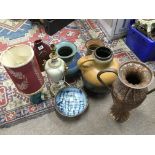 An assortment of pottery, lights and a copper hand