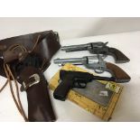 Four Replica toy guns one in a leather holster. (4