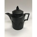 Am small black balasalt teapot with cover, half re