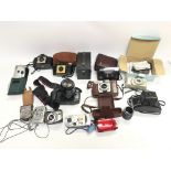 Collection of cameras and related items.