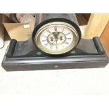 A large and heavy black slate mantle clock.