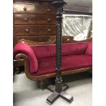 A Mahogany torchere with a spiral column. NO RESER