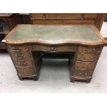 A 1930s walnut veneered leather topped desk. 115 x