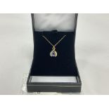 A 9ct gold diamond and tanzanite pendant on a 9ct gold chain with a yellow metal pendant set with