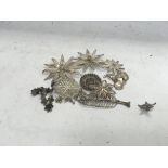 A collection of white metal Malaysian brooches a coin bracelet and other oddments