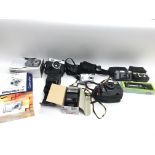 A collection of assorted cameras and accessories.