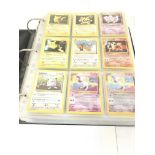 A Binder Containing a Collection Of vintage Pokemo