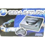 A Boxed Sega Saturn With 4 Games.