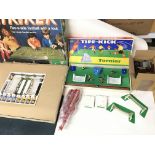 Two vintage table top football games and a box of various related accessories.