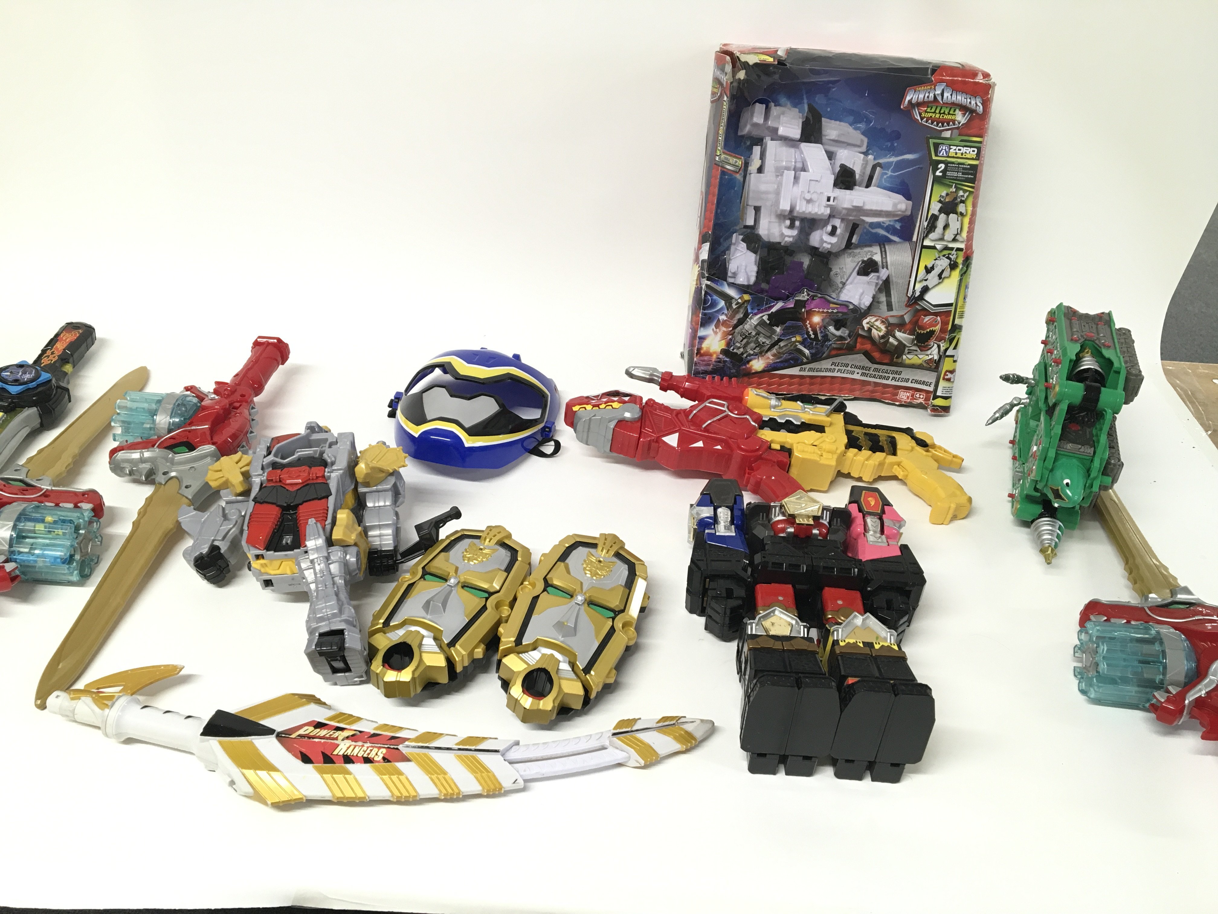 A large collection of assorted power Ranger items.