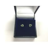 A pair of boxed 18ct white gold studs set with hea