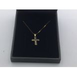 A 9ct gold diamond cross on a 9ct gold chain appro