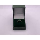 A 9ct gold ring set with a green stone (size M)