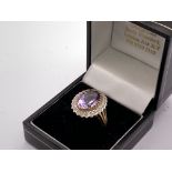 A 9ct gold amethyst and diamond set cluster ring.