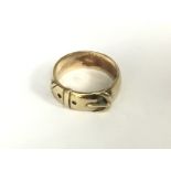 A heavy 9ct gold buckle design ring, Size V, appro