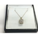 A boxed 9ct yellow gold multi cluster diamond pend