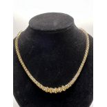A 14ct gold necklace set with graduating diamonds,