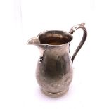 A hallmarked silver sparrow beaked jug with hallma