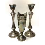 A pair of hallmarked silver weighted candlesticks