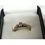 A 9carat gold ring set with a small solitary diamo