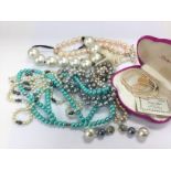 A collection of pearl necklaces and a pair of earr