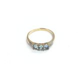 A 9ct gold ring set with blue topaz and diamonds,