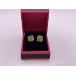 A pair of 9ct gold earrings set with half a ct yel