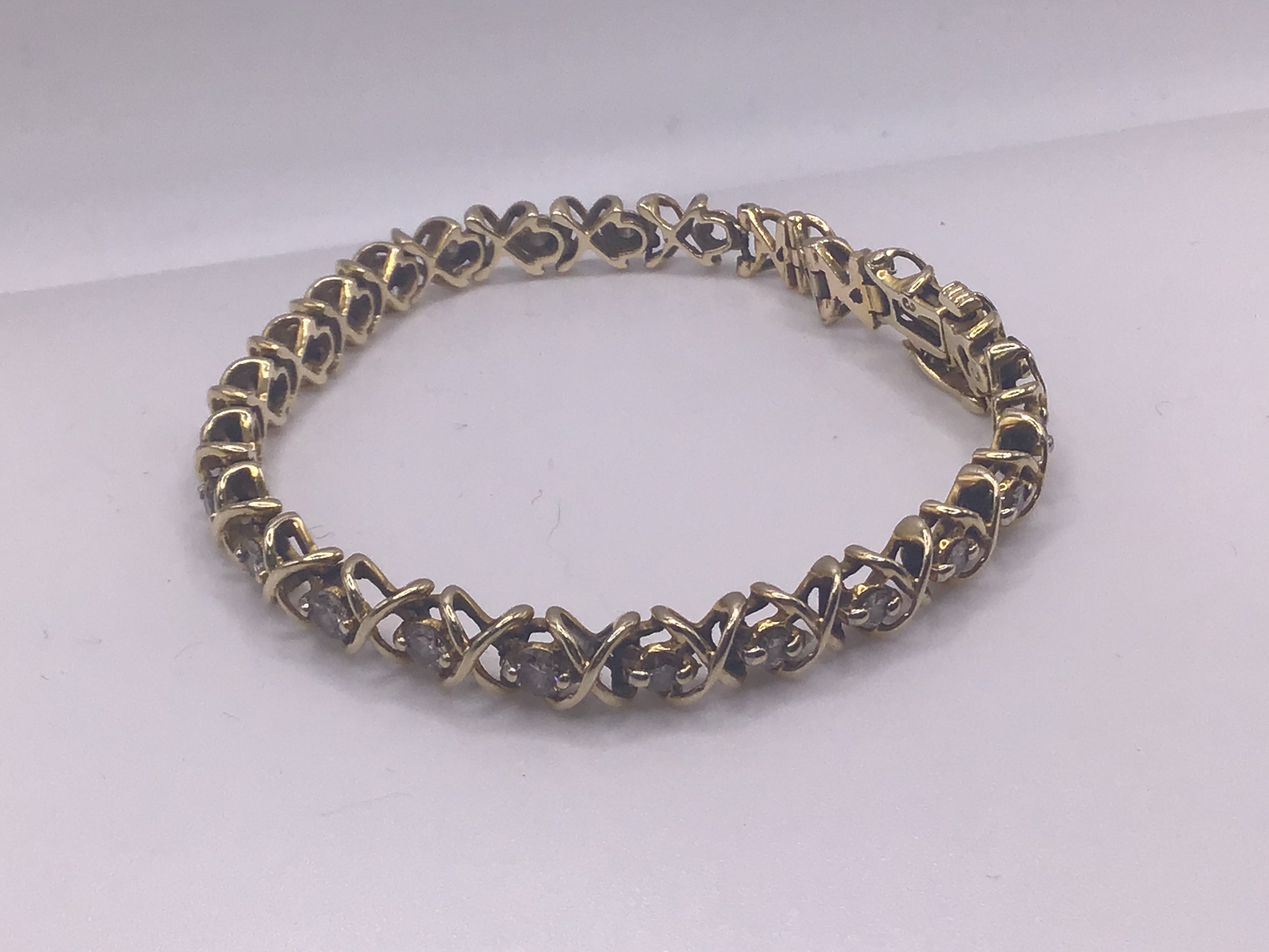 A 14ct yellow gold diamond line bracelet ( 1 stone