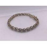 A 14ct yellow gold diamond line bracelet ( 1 stone