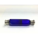 A double ended cobalt blue glass perfume bottle with silver tops and collars, approx 14cm.