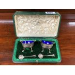 A cased pair of hallmarked silver table salts with