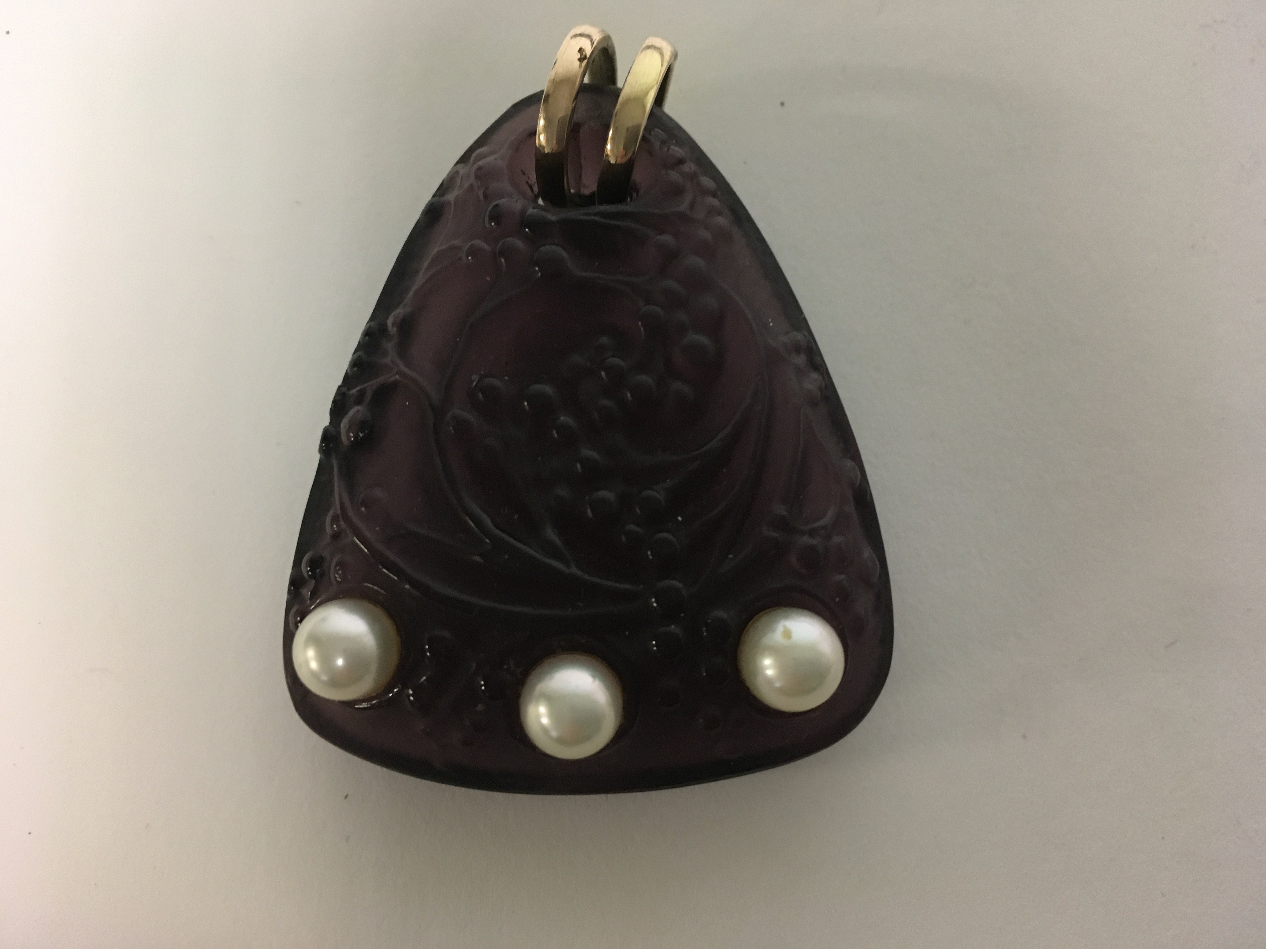 A Lalique amethyst berry design pendant with inset