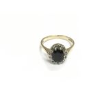 A 9ct gold ring set with small diamonds and sapphi