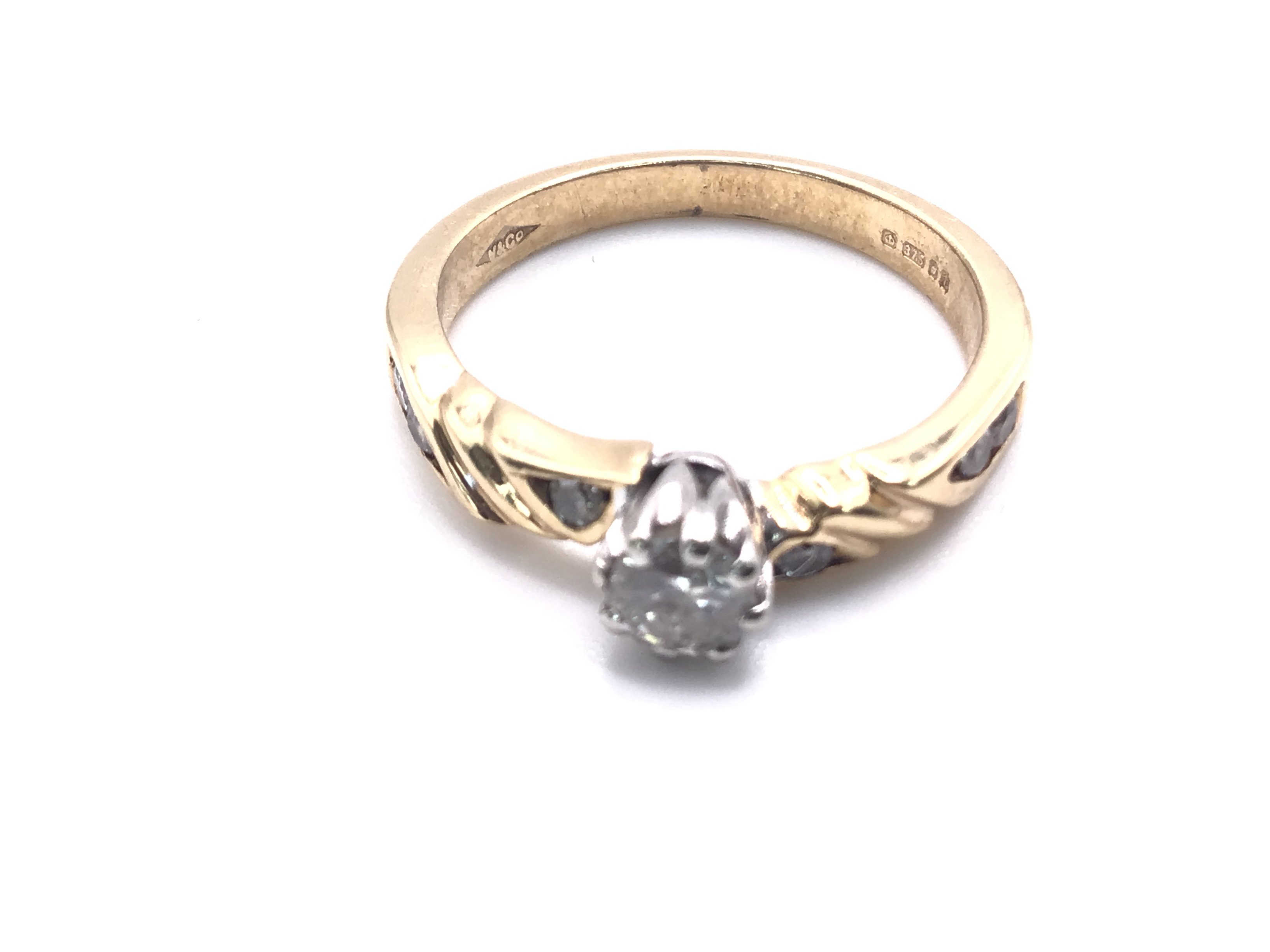 A 9 Ct Gold Dimond Solitaire with Diamonds on Band