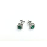 A pair of silver square cluster halo studs set wit