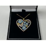 A Royal Mint issued heart design pendant with floral enamel and stone design.