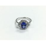 An 18ct white gold oval tanzanite and diamond clus